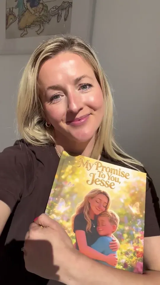 A mum smiles while holding her personalised mother and son storybook